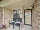 Inviting front porch features seating, a secure door, and a peaceful entry at 7360 Ulmerton Rd # 18A, Largo, FL 33771