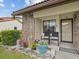 Inviting front porch with seating, decorative plants, and a well-manicured garden, perfect for enjoying the outdoors at 7360 Ulmerton Rd # 18A, Largo, FL 33771