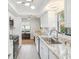 Bright kitchen with stainless steel appliances, sleek countertops, ample natural light, and stylish modern lighting at 7360 Ulmerton Rd # 18A, Largo, FL 33771