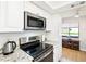 Updated kitchen with stainless steel appliances, granite countertops, modern cabinets, and natural light at 7360 Ulmerton Rd # 18A, Largo, FL 33771