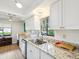 Bright kitchen with stainless steel appliances, sleek countertops, ample natural light, and stylish modern lighting at 7360 Ulmerton Rd # 18A, Largo, FL 33771