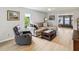 Comfortable living room with a gray sectional couch, recliner, and light hardwood flooring at 7360 Ulmerton Rd # 18A, Largo, FL 33771
