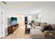 Spacious living room with a gray sectional couch, hardwood flooring, and entertainment center at 7360 Ulmerton Rd # 18A, Largo, FL 33771