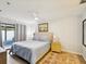 Main bedroom with king bed, ceiling fan, an exterior door, and carpet at 7360 Ulmerton Rd # 18A, Largo, FL 33771