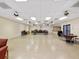 Spacious meeting room with tables, chairs, ceiling fans, and an exit at 7360 Ulmerton Rd # 18A, Largo, FL 33771