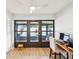 Home office with a desk, chair, computer, and access to the screened-in lanai at 7360 Ulmerton Rd # 18A, Largo, FL 33771