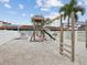 Community playground in a sand area featuring a slide and climbing structure at 7360 Ulmerton Rd # 18A, Largo, FL 33771