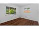 Cozy bedroom with wood-look flooring and bright, natural light from the windows at 8020 24Th Ave N, St Petersburg, FL 33710