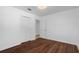 Comfortable bedroom with wood-look flooring, closet and modern light fixture at 8020 24Th Ave N, St Petersburg, FL 33710