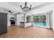 Bright dining room with chandelier, open to the kitchen, with views of the pool through sliding glass doors at 8020 24Th Ave N, St Petersburg, FL 33710