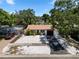Aerial view of single story home with a brown roof, white siding and a driveway at 8020 24Th Ave N, St Petersburg, FL 33710