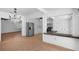 View of the kitchen featuring a stainless steel refrigerator and breakfast bar, open to the living spaces at 8020 24Th Ave N, St Petersburg, FL 33710