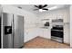 Well-lit kitchen featuring stainless steel appliances, white cabinets, and tile flooring at 8020 24Th Ave N, St Petersburg, FL 33710