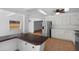 Kitchen features modern appliances, white cabinetry, and a breakfast bar overlooking other living spaces at 8020 24Th Ave N, St Petersburg, FL 33710