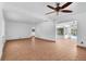 Open-concept living room with tile flooring and ceiling fan, offering a view of the pool through the windows at 8020 24Th Ave N, St Petersburg, FL 33710