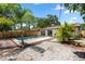Outdoor pool with brick and white gravel patio and nice landscaping at 8020 24Th Ave N, St Petersburg, FL 33710