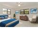Comfortable bedroom featuring a blue bedframe, ceiling fan, and plenty of natural light at 8020 28Th N Ave, St Petersburg, FL 33710