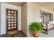 A well-lit entryway with a decorative front door, bench and potted fern at 8020 28Th N Ave, St Petersburg, FL 33710