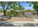Exterior of a well maintained tan single-story home with a landscaped front yard and mature trees at 8020 28Th N Ave, St Petersburg, FL 33710