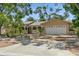 Charming single-story home with a two-car garage, arched entry and tropical landscaping at 8020 28Th N Ave, St Petersburg, FL 33710