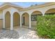 Charming covered front porch featuring archways leading to a decorative front door at 8020 28Th N Ave, St Petersburg, FL 33710