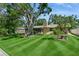 Charming home with mature trees and a beautifully landscaped front yard at 8020 28Th N Ave, St Petersburg, FL 33710