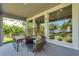 Cozy covered back porch with stylish seating, offering a relaxing outdoor space and a view of the backyard at 8095 35Th Ave N, St Petersburg, FL 33710