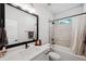 Elegant bathroom features a black framed mirror, large vanity and shower-tub combo at 8095 35Th Ave N, St Petersburg, FL 33710