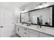 Bright bathroom with dual sinks, sleek white cabinetry, and a large mirror at 8095 35Th Ave N, St Petersburg, FL 33710