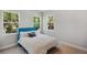 Serene bedroom with natural light from three windows and a blue upholstered bed at 8095 35Th Ave N, St Petersburg, FL 33710