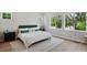 Bright bedroom featuring light walls, wood floors, and large windows overlooking the trees at 8095 35Th Ave N, St Petersburg, FL 33710