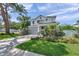 Charming two-story home with well-manicured lawn and a gray color scheme and a covered front porch at 8095 35Th Ave N, St Petersburg, FL 33710