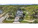 Charming two-story home featuring solar panels, a well-manicured lawn, and mature landscaping at 8095 35Th Ave N, St Petersburg, FL 33710