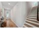 Inviting foyer with wood floors, front door with decorative glass, and stairway to upper level at 8095 35Th Ave N, St Petersburg, FL 33710
