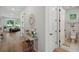 Inviting hallway with stylish decor, leading to a bright living area and a half bathroom at 8095 35Th Ave N, St Petersburg, FL 33710