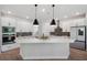 Bright kitchen with white cabinets, stainless steel appliances, a gray backsplash, and a center island at 8095 35Th Ave N, St Petersburg, FL 33710