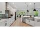 Well-lit kitchen with stainless steel appliances and island flowing into the living room and dining area at 8095 35Th Ave N, St Petersburg, FL 33710