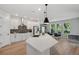 White kitchen featuring stainless steel appliances, backsplash, and a center island with pendant lighting at 8095 35Th Ave N, St Petersburg, FL 33710