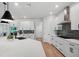 Modern kitchen featuring white cabinetry, stone backsplash, stainless steel appliances, and quartz countertops at 8095 35Th Ave N, St Petersburg, FL 33710