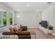 Inviting living room area with large sofa, wood floors, recessed lighting, and television at 8095 35Th Ave N, St Petersburg, FL 33710