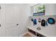 Well-organized mud room with a bench, hooks, shelving, and stylish decor at 8095 35Th Ave N, St Petersburg, FL 33710