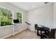 Office space featuring wood floors, natural light, a work station, and small conference table at 8095 35Th Ave N, St Petersburg, FL 33710