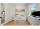 Open office space featuring wood floors, two printers, artwork, and access to the kitchen at 8095 35Th Ave N, St Petersburg, FL 33710