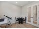 Office with wood floors, telescope, table with chairs, and view into hallway at 8095 35Th Ave N, St Petersburg, FL 33710