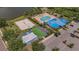 Aerial view showing the community pool, clubhouse, shuffleboard, and beach volleyball near a parking lot at 8223 Haven Harbour Way, Bradenton, FL 34212