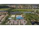 Aerial view showing the community pool, volleyball court, playground, and tennis courts near lakes at 8223 Haven Harbour Way, Bradenton, FL 34212