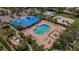 Aerial view of the pool and clubhouse, surrounded by a spacious pool deck, and palm trees at 8223 Haven Harbour Way, Bradenton, FL 34212