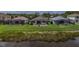 The rear of houses with screened-in pools and green lawns offer views of the lake at 8223 Haven Harbour Way, Bradenton, FL 34212