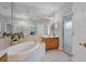 Bright bathroom with a soaking tub, vanity, and separate shower at 8223 Haven Harbour Way, Bradenton, FL 34212