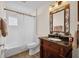 Well-lit bathroom featuring a vanity, mirror, and shower-tub combination at 8223 Haven Harbour Way, Bradenton, FL 34212
